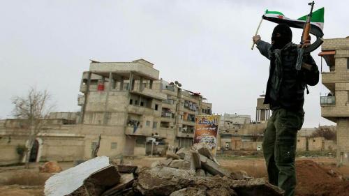 a-syrian-soldier-who-has-defected-to-join-the-free-syrian-army-holds-up-his-rifle-and-waves-a-syrian-independence-flag-in-saqba-in-damascus-suburbs-enero-2012.jpg