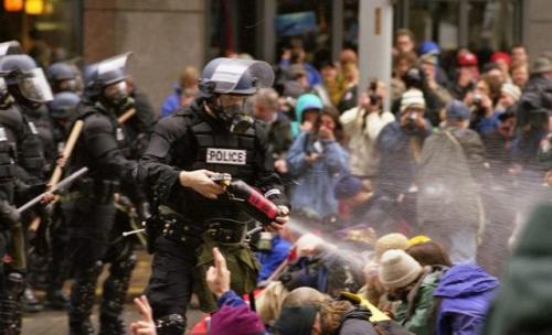 riot_police_pepper_spray_nonviolent_demonstrators_at_the_1999_seattle_world_trade_organization_protests-_steve_kaiser_-flickr.jpg